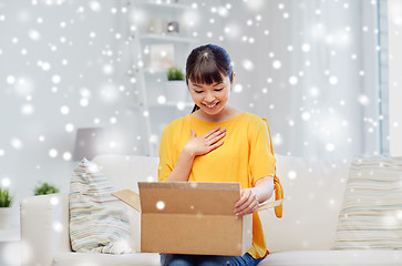 Image showing happy asian young woman with parcel box at home