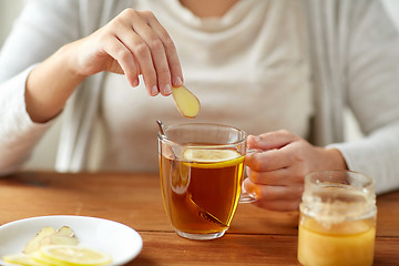 Image showing close up of ill woman drinking tea with ginger