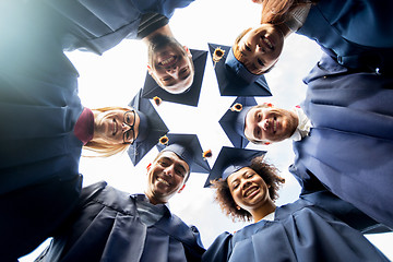 Image showing happy students or bachelors in mortar boards