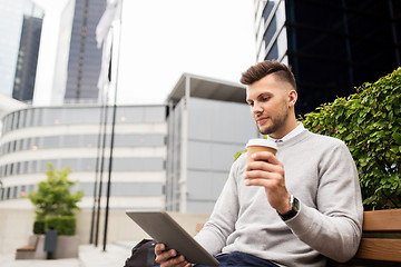 Image showing man with tablet pc and coffee on city street bench