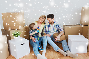 Image showing happy family with boxes moving to new home