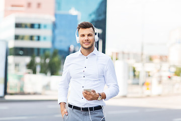 Image showing man with headphones and smartphone listening music