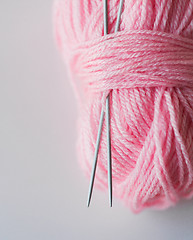 Image showing close up of knitting needles and pink yarn ball 