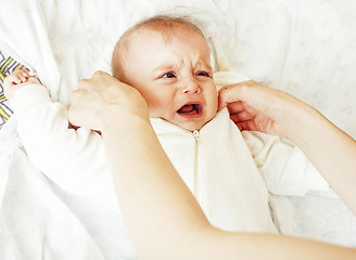 Image showing Mother carrying clothers for baby todler little son crying, unha