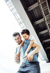 Image showing mature father with his son under the bridge having fun together 