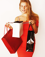 Image showing young pretty blond woman with bags on Christmas sale in red dres