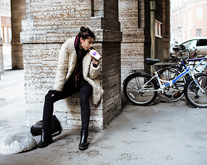 Image showing young pretty stylish teenage girl outside at city wall with graf