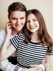 Image showing couple of happy smiling teenagers students, warm colors having a