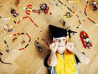 Image showing little cute preschooler boy among toys lego at home in graduate 