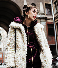 Image showing young pretty stylish teenage girl outside at city wall with graf