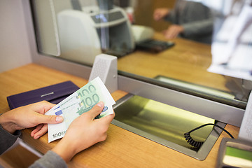 Image showing hands with money at bank or currency exchanger