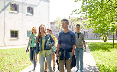 Image showing group of happy teenage students walking outdoors