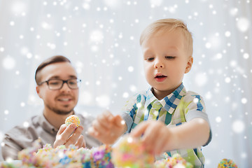 Image showing father and son playing with ball clay at home