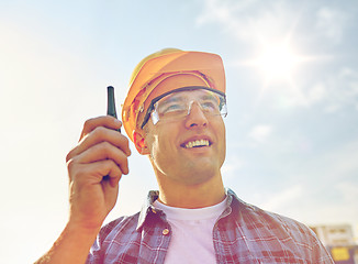 Image showing close up of builder in hardhat with walkie talkie