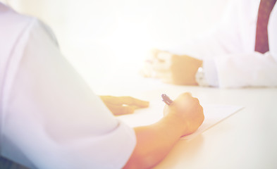 Image showing close up of doctor taking notes at hospital