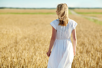 Image showing young woman in white dress on cereal field