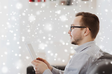 Image showing man with tablet pc at home over snow