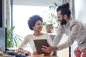 Image showing happy creative team with tablet pc in office