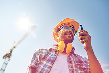 Image showing builder in hardhat with walkie talkie