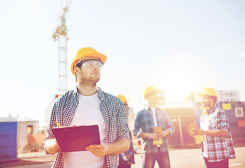 Image showing group of builders in hardhats outdoors