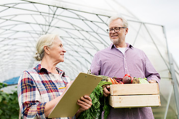 Image showing senior couple with box of vegetables on farm