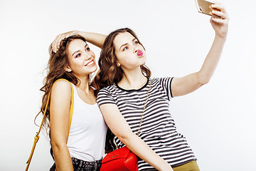 Image showing two best friends teenage girls together having fun, posing emotional on white background, besties happy smiling, making selfie, lifestyle people concept