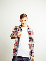 Image showing young handsome teenage hipster guy posing emotional, happy smiling against white background isolated, lifestyle people concept