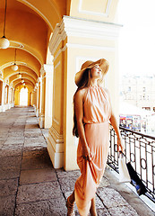 Image showing young pretty smiling woman in hat with bags on shopping at store