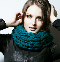 Image showing young pretty real woman in sweater and scarf all over her face s