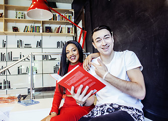 Image showing couple students in univercity library, looking book, preparing t