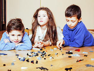 Image showing funny cute children playing lego at home, boys and girl smiling, first education role lifestyle