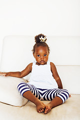 Image showing little pretty african american girl sitting in white chair weari