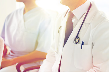 Image showing close up of happy doctors at seminar or hospital