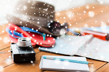 Image showing close up of camera, notebook and travel stuff