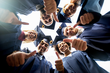 Image showing happy students or bachelors in mortar boards