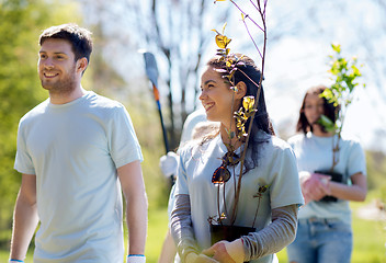 Image showing group of volunteers with trees and rake in park