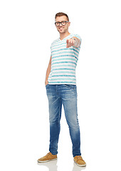 Image showing smiling man in eyeglasses pointing finger to you