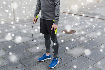 Image showing close up of man exercising with jump-rope outdoors