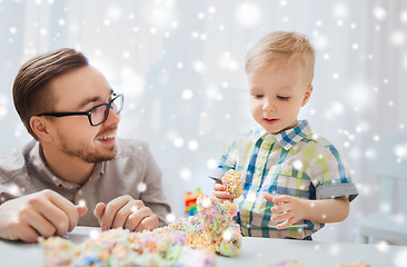 Image showing father and son playing with ball clay at home