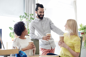 Image showing happy creative team drinking coffee in office