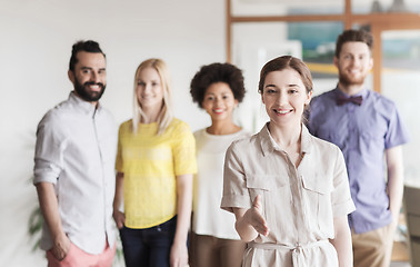 Image showing woman making handshake over creative office team