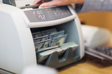 Image showing dollars in electronic money counter at bank office