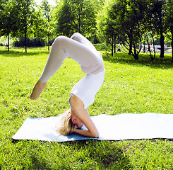 Image showing blonde girl doing yoga in green park