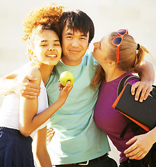 Image showing cute group of teenages at the building of university with books huggings, diversity nations