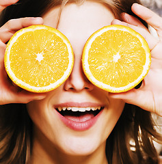 Image showing young pretty girl with orange close up