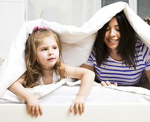 Image showing Portrait of mother and daughter playing in bed, lifestyle people concept
