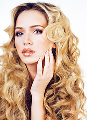 Image showing beauty blond woman with long curly hair close up isolated, hairs