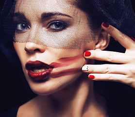 Image showing beauty brunette woman under black veil with red manicure close up