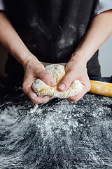 Image showing Person covering pastry with flour