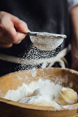 Image showing Person covering pastry with flour